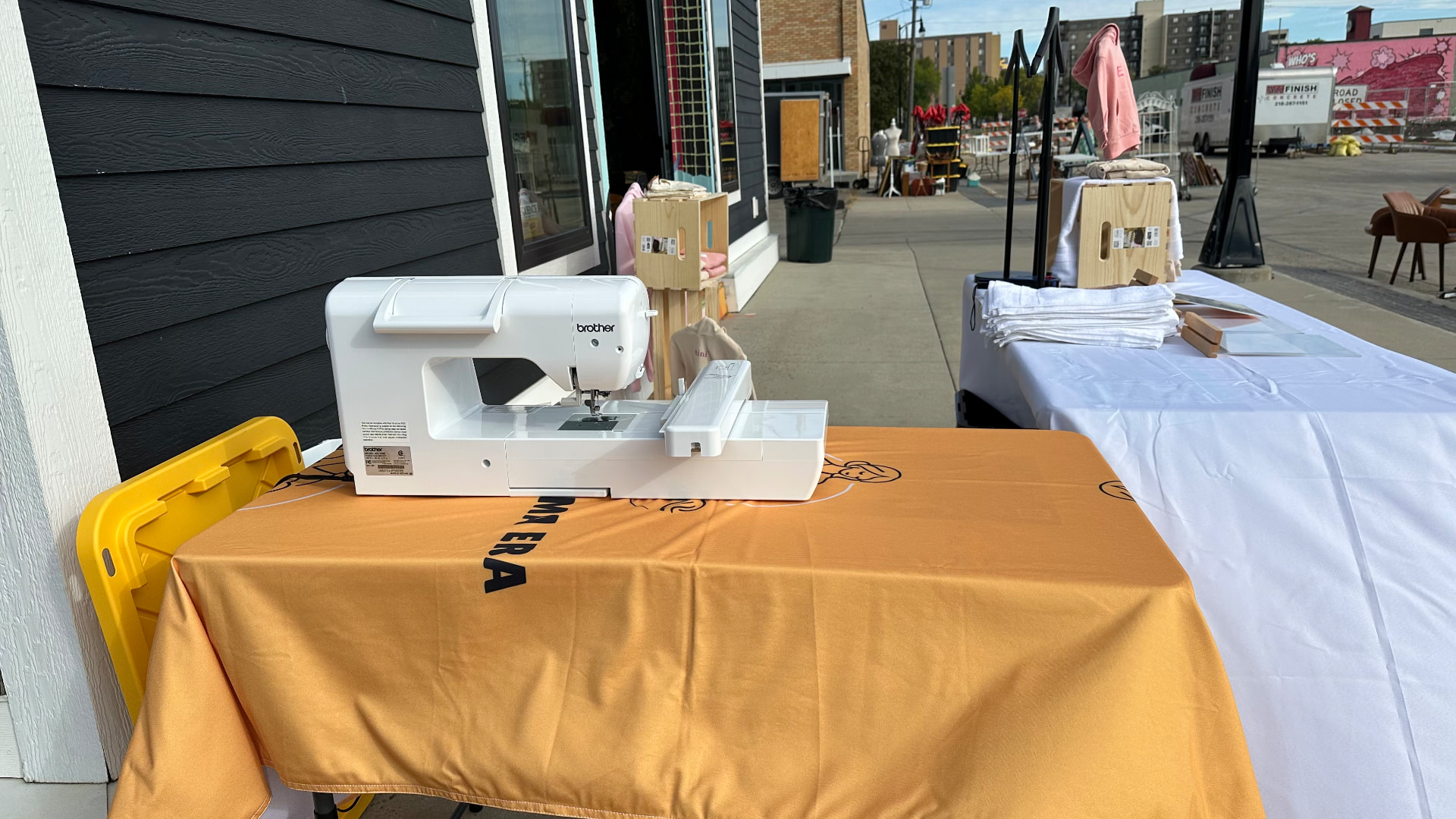Brother single-needle embroidery machine stitching live at a Fargo market event
